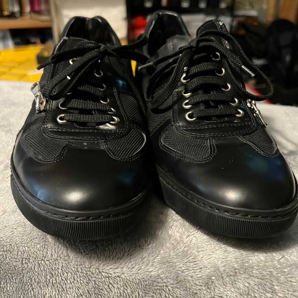 Black designer sneakers w/zippers on the side.
